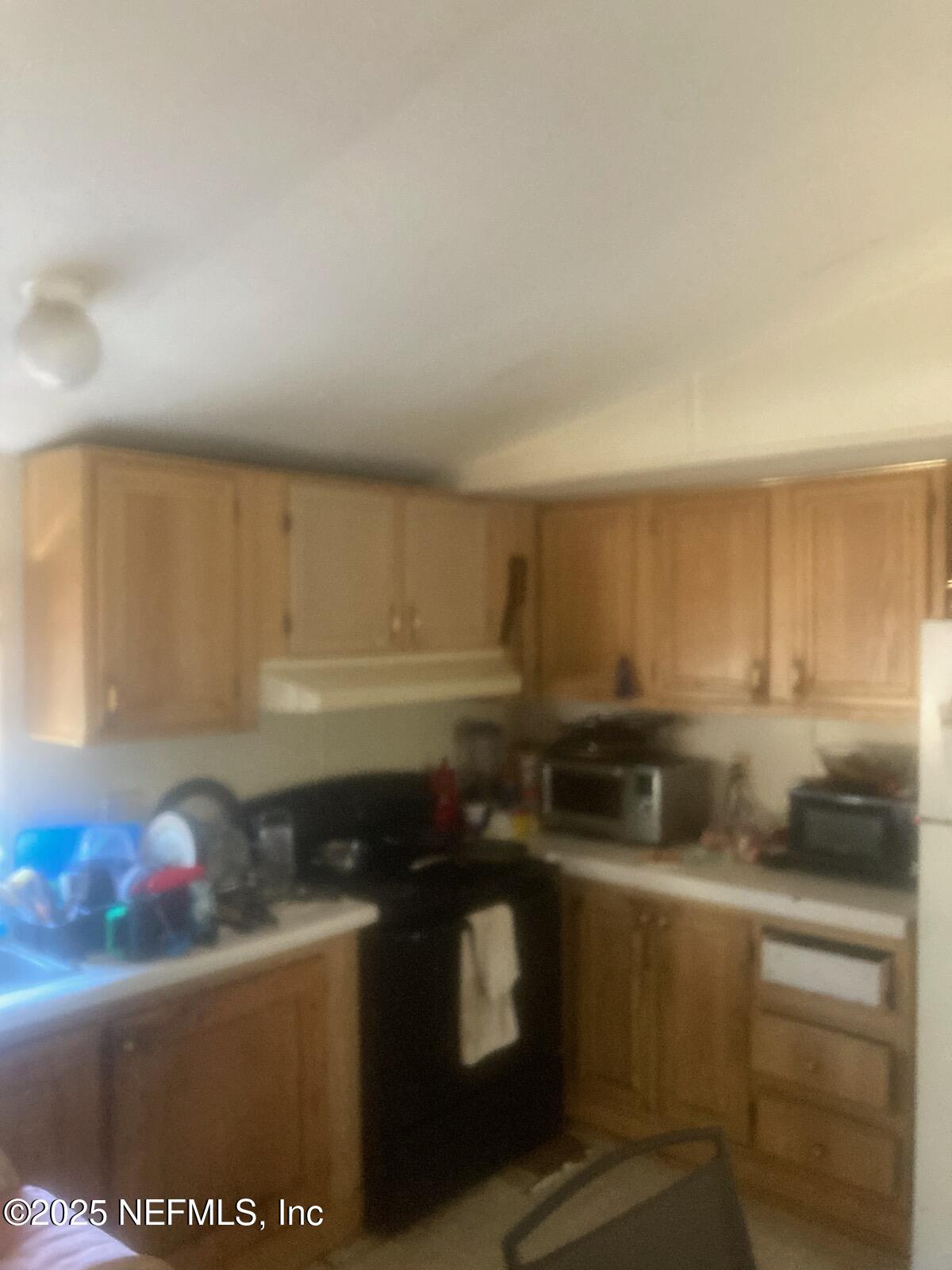12491 Northeast 88th Lane Bronson, FL 32621 - Photo 17 of 183 a kitchen with stainless steel appliances granite countertop a stove a sink and a refrigerator