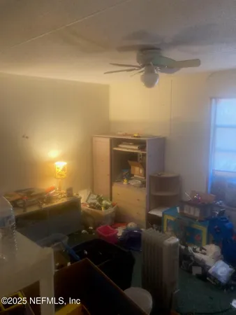 a living room with furniture a large window and a flat screen tv