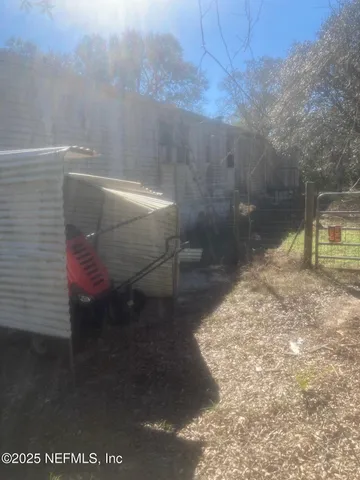 a living room with furniture a window and a flat screen tv