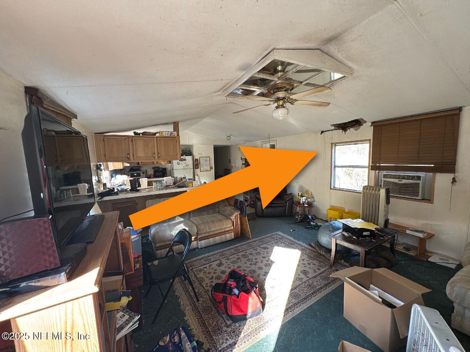 12491 Northeast 88th Lane Bronson, FL 32621 - Photo 30 of 183 a living room with furniture kitchen view and a wooden floor