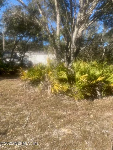 a kitchen with a table chairs and a refrigerator
