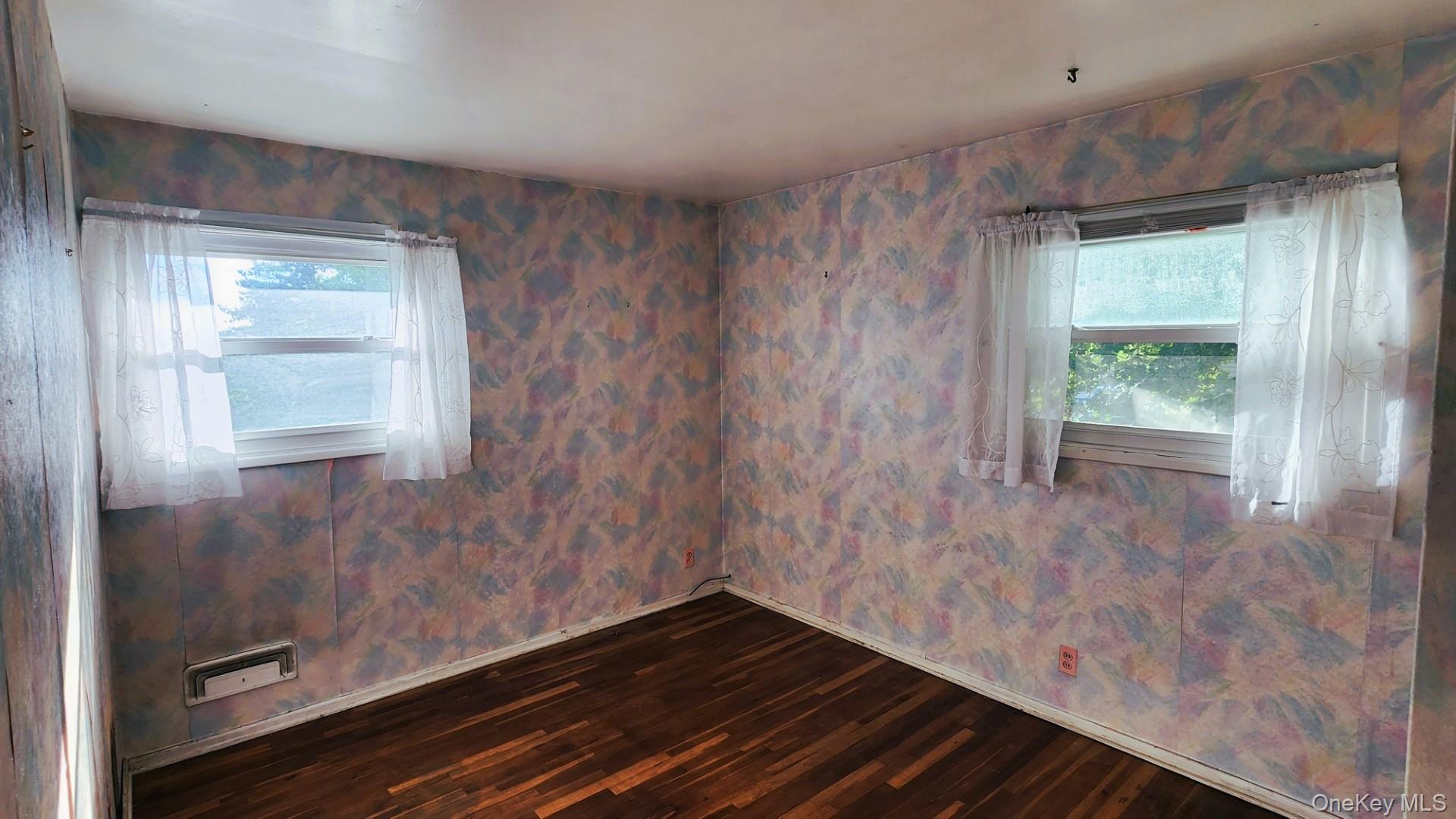 32 Bloomer Road Brewster, NY 10509 - Photo 14 of 18 Spare room featuring wallpapered walls, dark wood-type flooring, and healthy amount of natural light