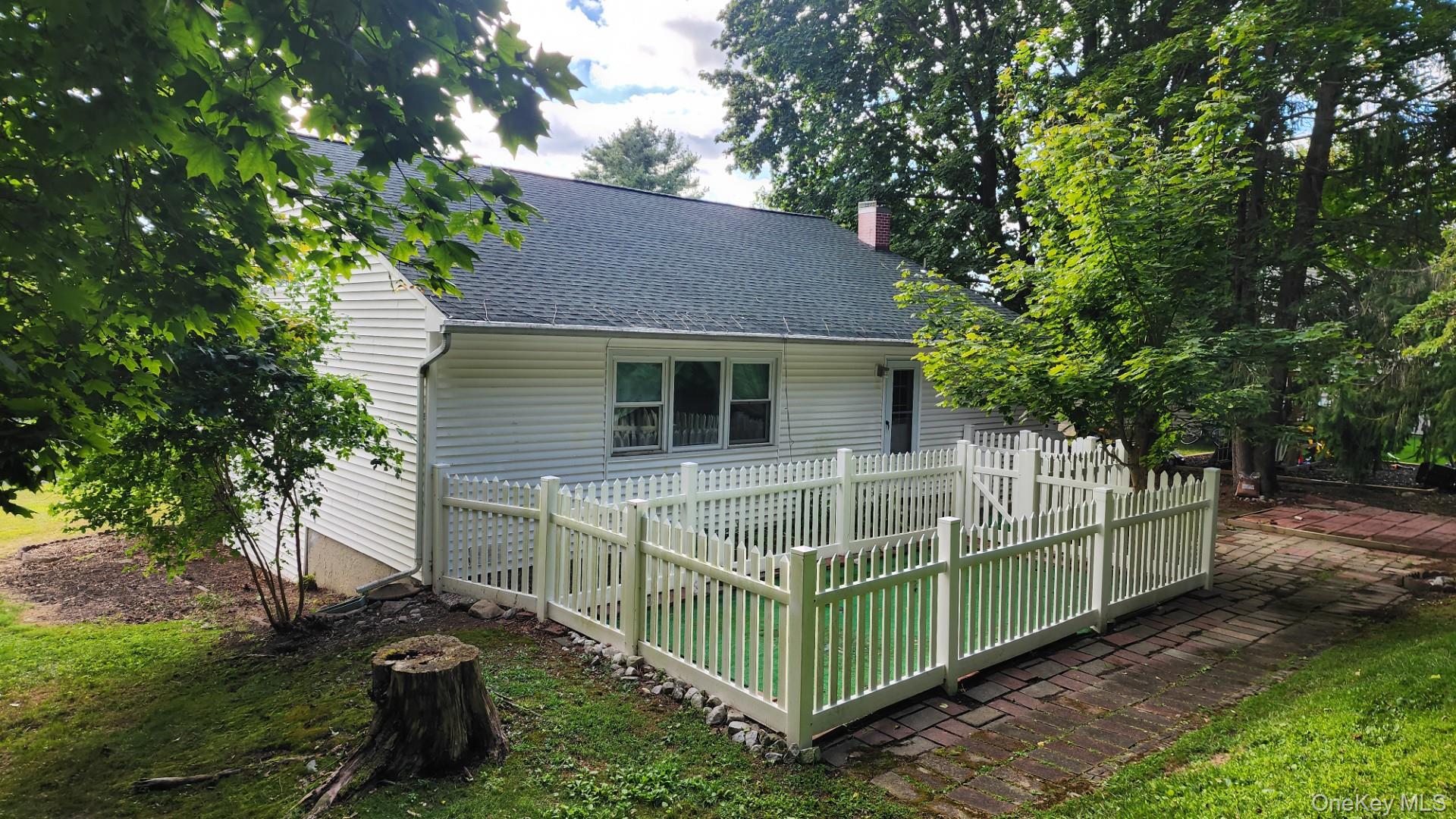 32 Bloomer Road Brewster, NY 10509 - Photo 3 of 18 Rear view of house featuring roof with shingles, a deck, and a chimney