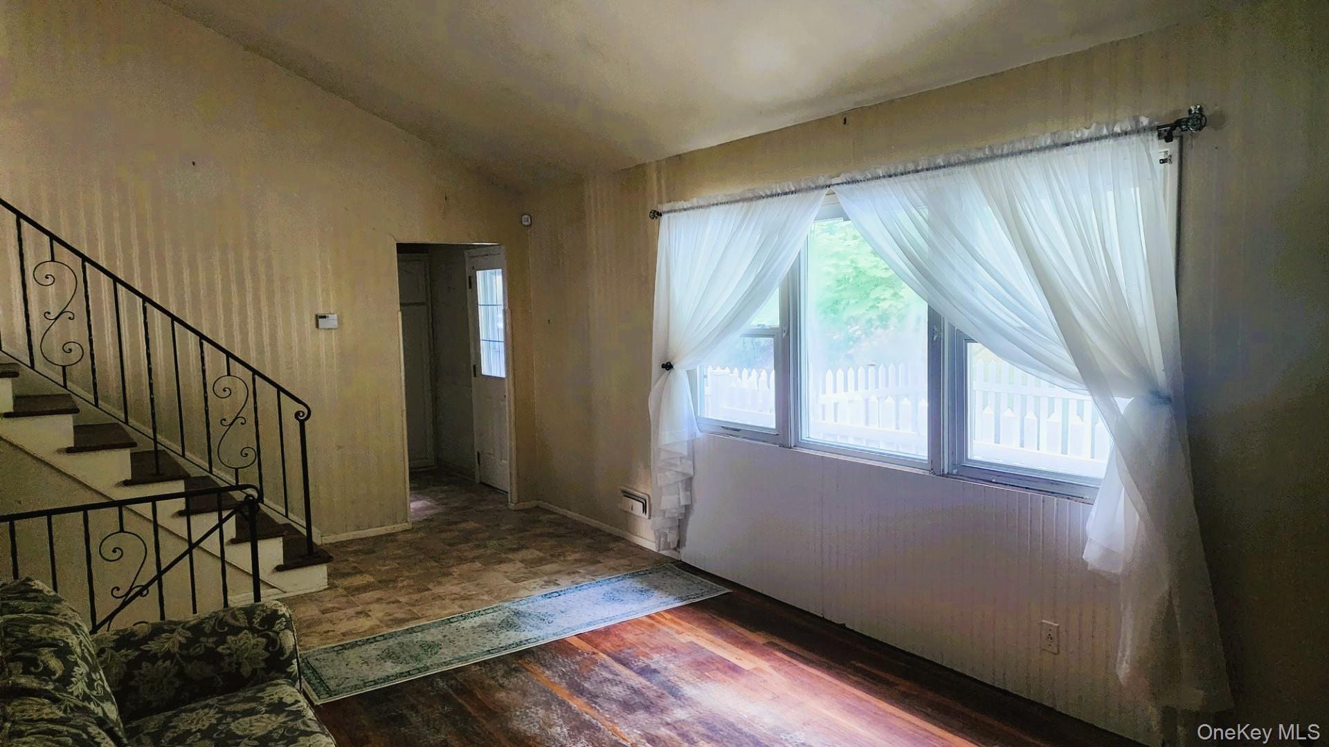 32 Bloomer Road Brewster, NY 10509 - Photo 7 of 18 Entrance foyer featuring lofted ceiling, stairway, and dark wood-style floors