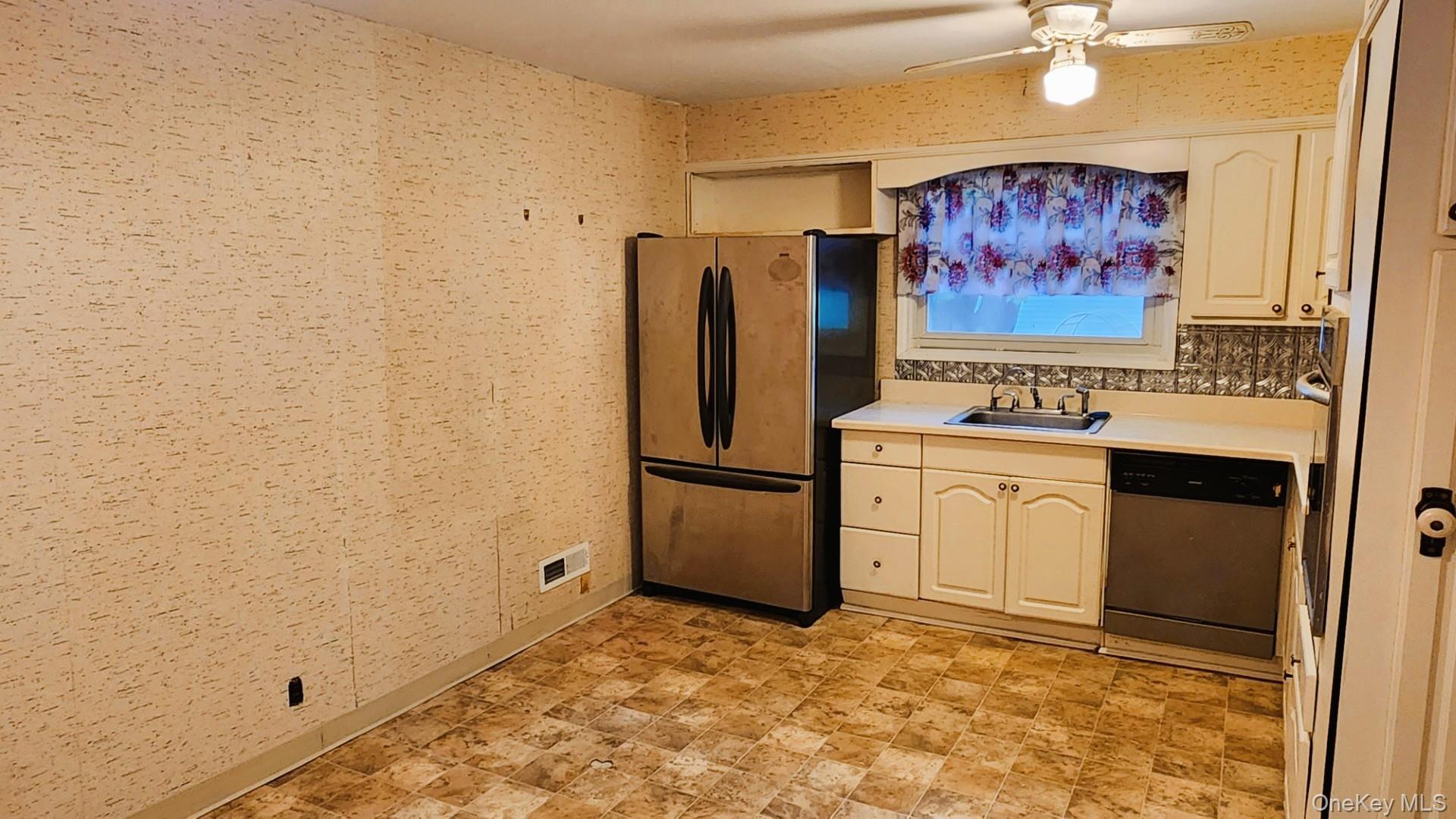 32 Bloomer Road Brewster, NY 10509 - Photo 9 of 18 Kitchen featuring light countertops, wallpapered walls, stainless steel appliances, and a ceiling fan