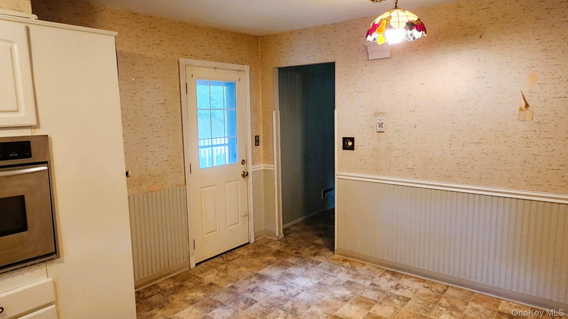32 Bloomer Road Brewster, NY 10509 - Photo 10 of 18 Entryway featuring a wainscoted wall and wallpapered walls