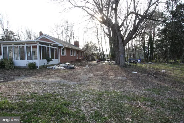 a view of a house with a yard and trees