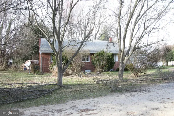 a view of a house with a trees in the background