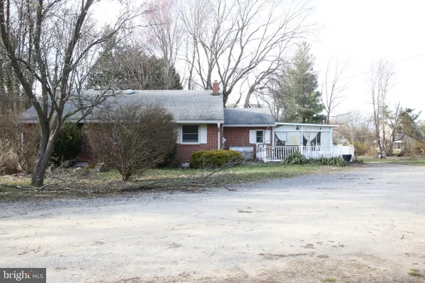a view of a house with a yard covered with snow