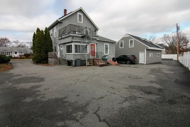 a view of a house with a big yard and large trees