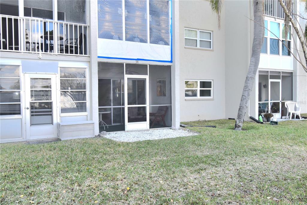 952 Virginia Street, Unit 107 Dunedin, FL 34698 - Photo 11 of 15 a view of front door of house with yard