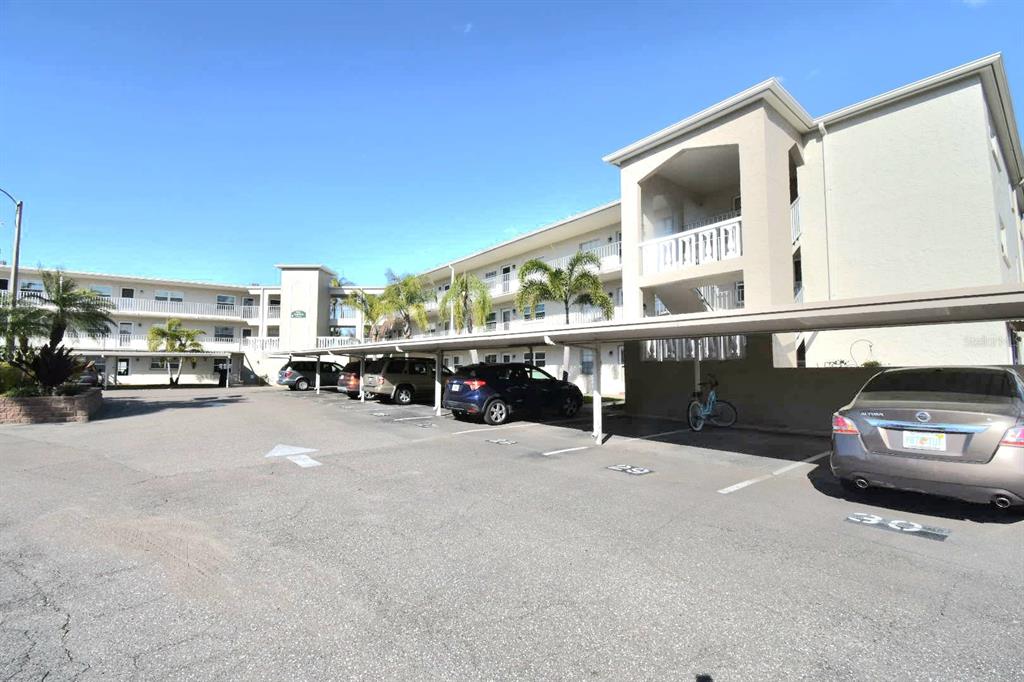 952 Virginia Street, Unit 107 Dunedin, FL 34698 - Photo 2 of 15 a car parked in front of a building