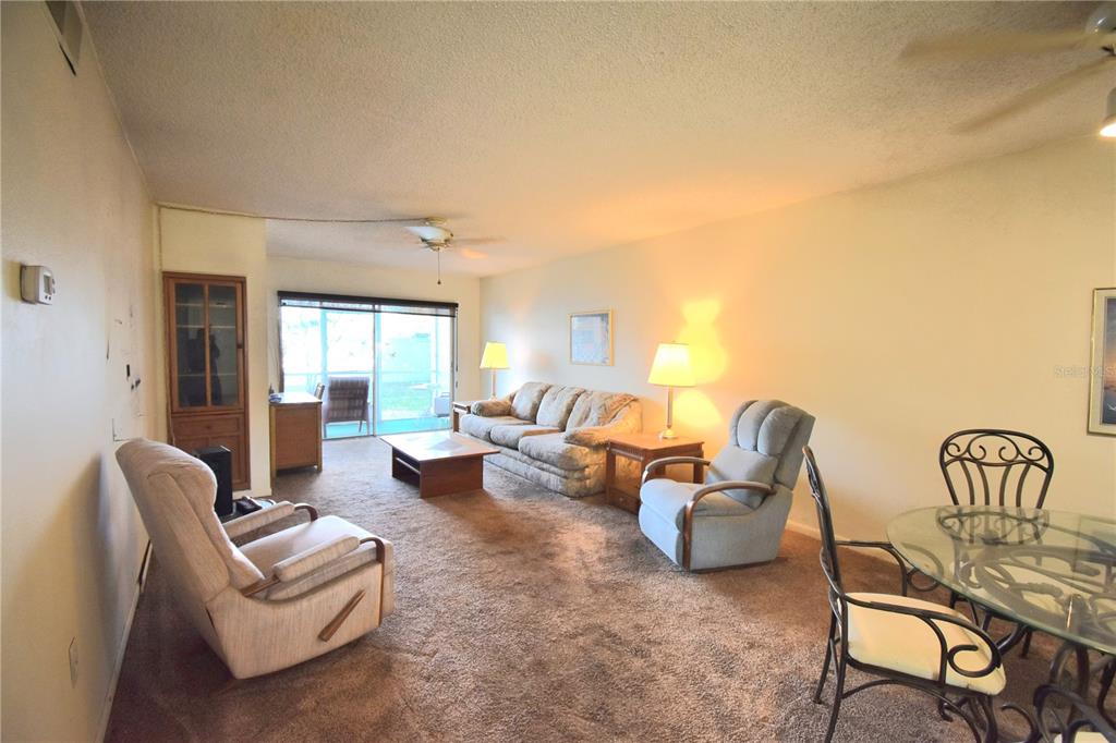 952 Virginia Street, Unit 107 Dunedin, FL 34698 - Photo 8 of 15 a living room with furniture and a window