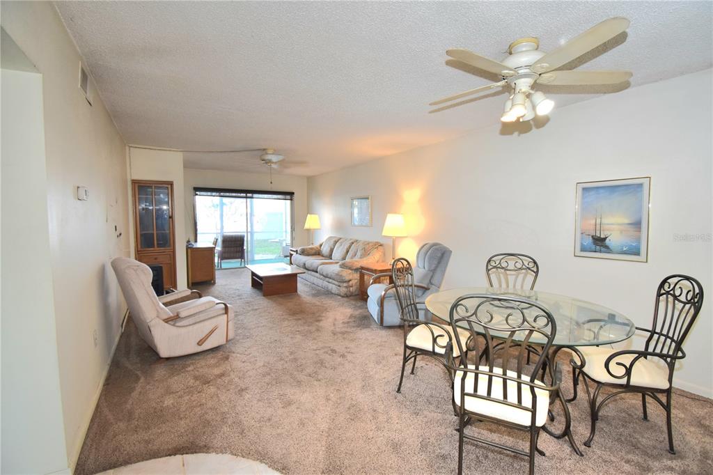 952 Virginia Street, Unit 107 Dunedin, FL 34698 - Photo 9 of 15 a living room with furniture and a ceiling fan