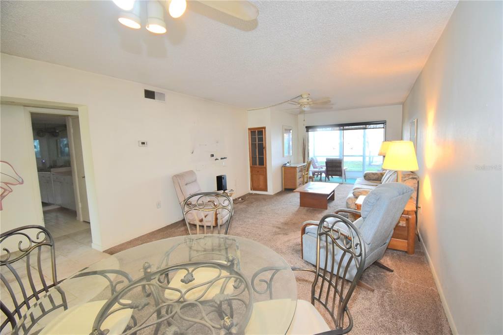 952 Virginia Street, Unit 107 Dunedin, FL 34698 - Photo 10 of 15 a living room with furniture and a large window