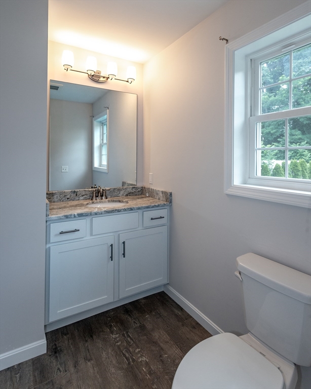 50 Edbert Street Chicopee, MA 01020 - Photo 18 of 42 a bathroom with a granite countertop toilet sink and mirror