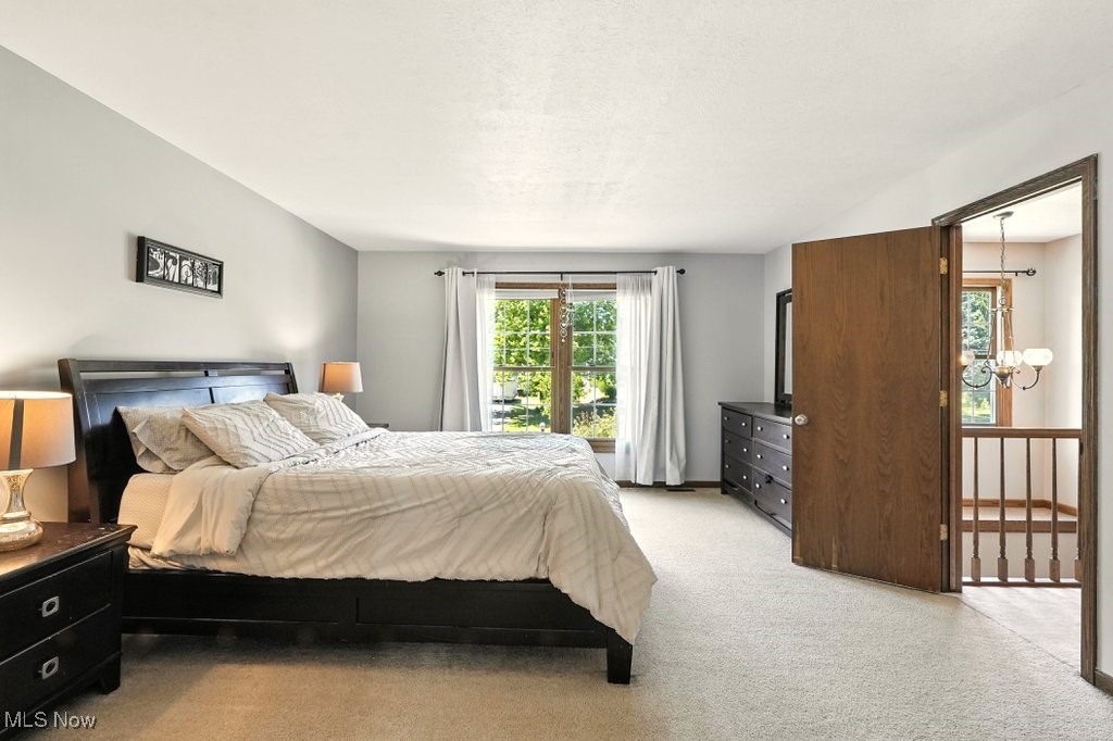 3339 Marsh Road Stow, OH 44224 - Photo 17 of 27 Bedroom with a chandelier, light carpet, and a textured ceiling