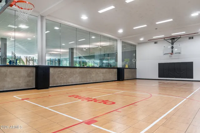 a view of an empty room with kitchen and a counter top space