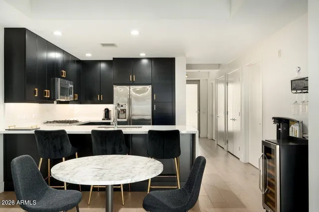 a kitchen with stainless steel appliances kitchen island granite countertop a sink and cabinets