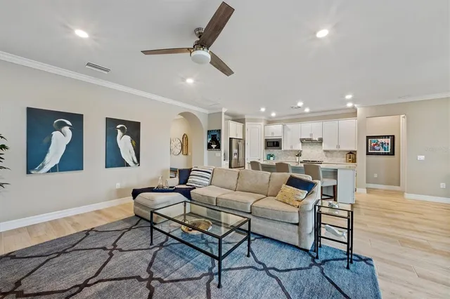 a living room with furniture and kitchen view
