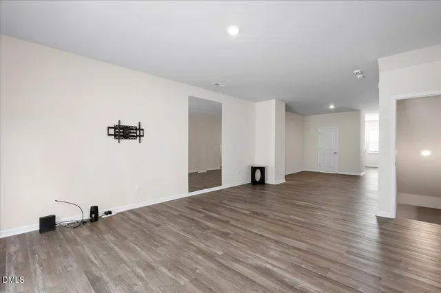 a view of a room with wooden floor