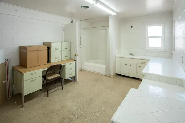 wooden bathroom with a sink and mirror