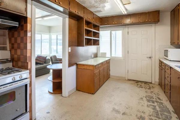 a kitchen with stainless steel appliances granite countertop a refrigerator and a sink