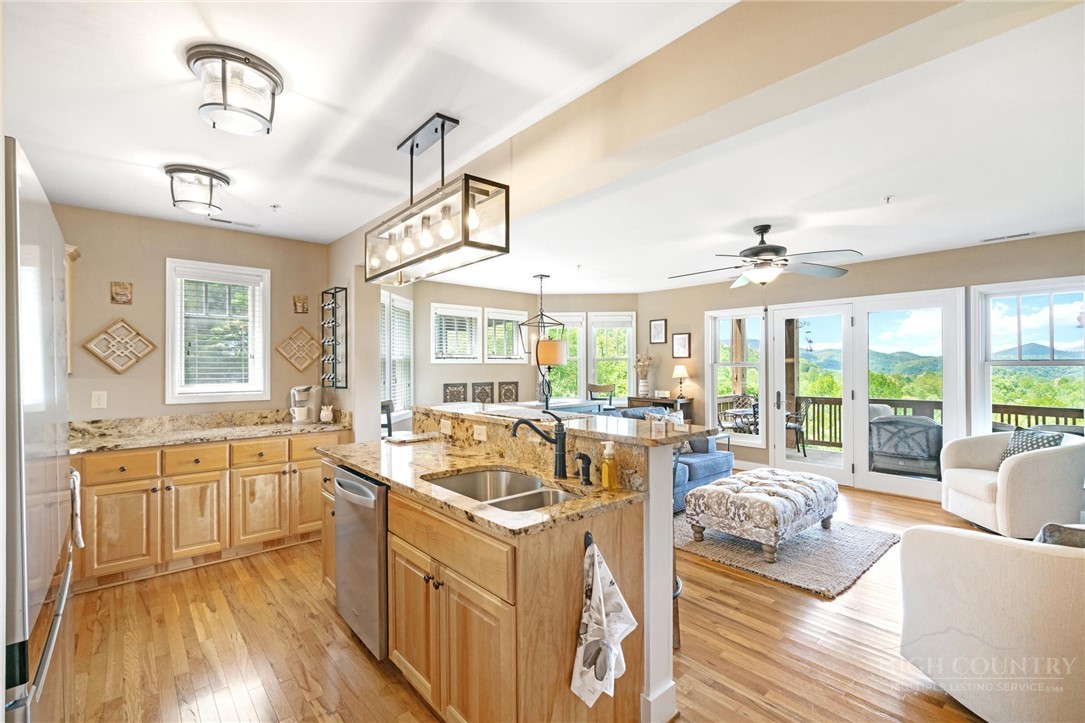 942 Ridge Haven Parkway, Unit R1211 Banner Elk, NC 28604 - Photo 6 of 45 a large white kitchen with a large window and furniture