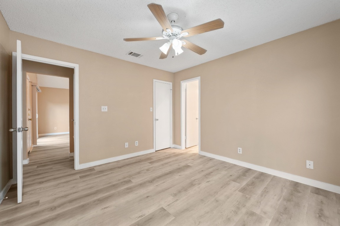 16016 Fitchburg Circle Pflugerville, TX 78660 - Photo 13 of 22 a view of an empty room with wooden floor