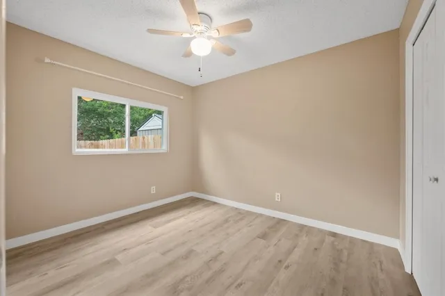 wooden floor in an empty room with a window