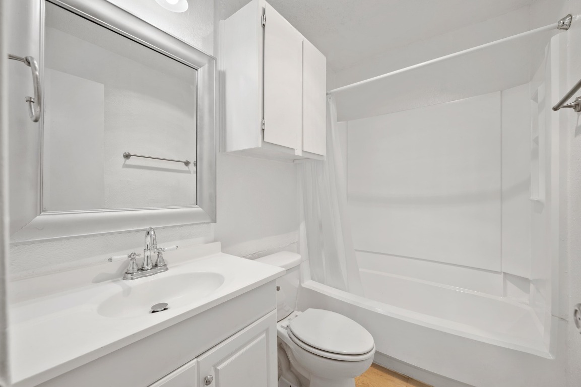 16016 Fitchburg Circle Pflugerville, TX 78660 - Photo 18 of 22 a bathroom with a bathtub shower sink vanity and toilet