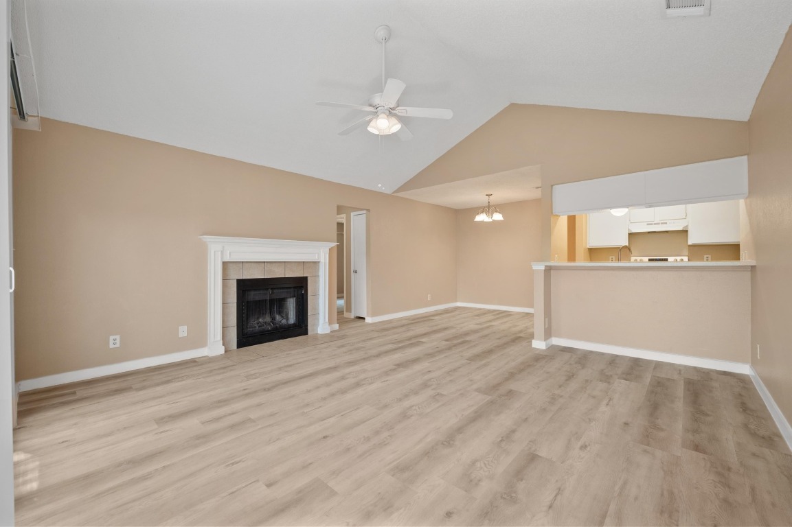 16016 Fitchburg Circle Pflugerville, TX 78660 - Photo 3 of 22 a view of a livingroom with wooden floor and a fireplace
