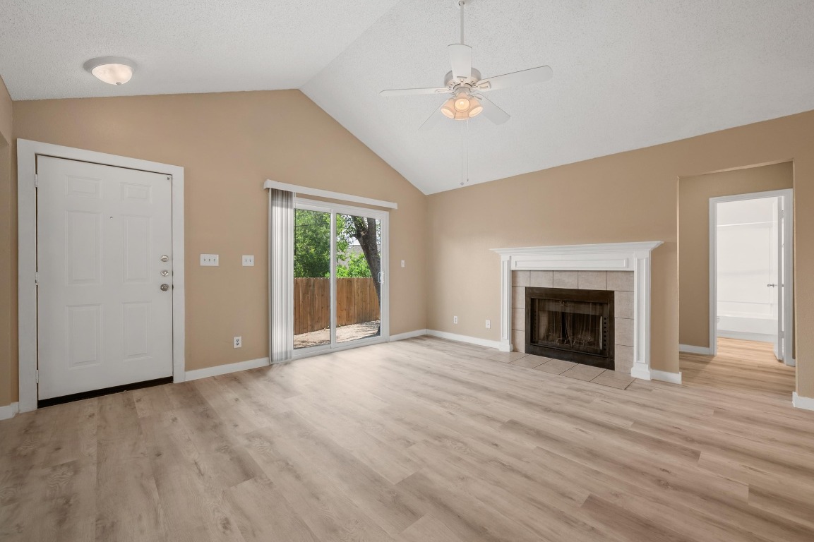 16016 Fitchburg Circle Pflugerville, TX 78660 - Photo 4 of 22 an empty room with windows fireplace and sink