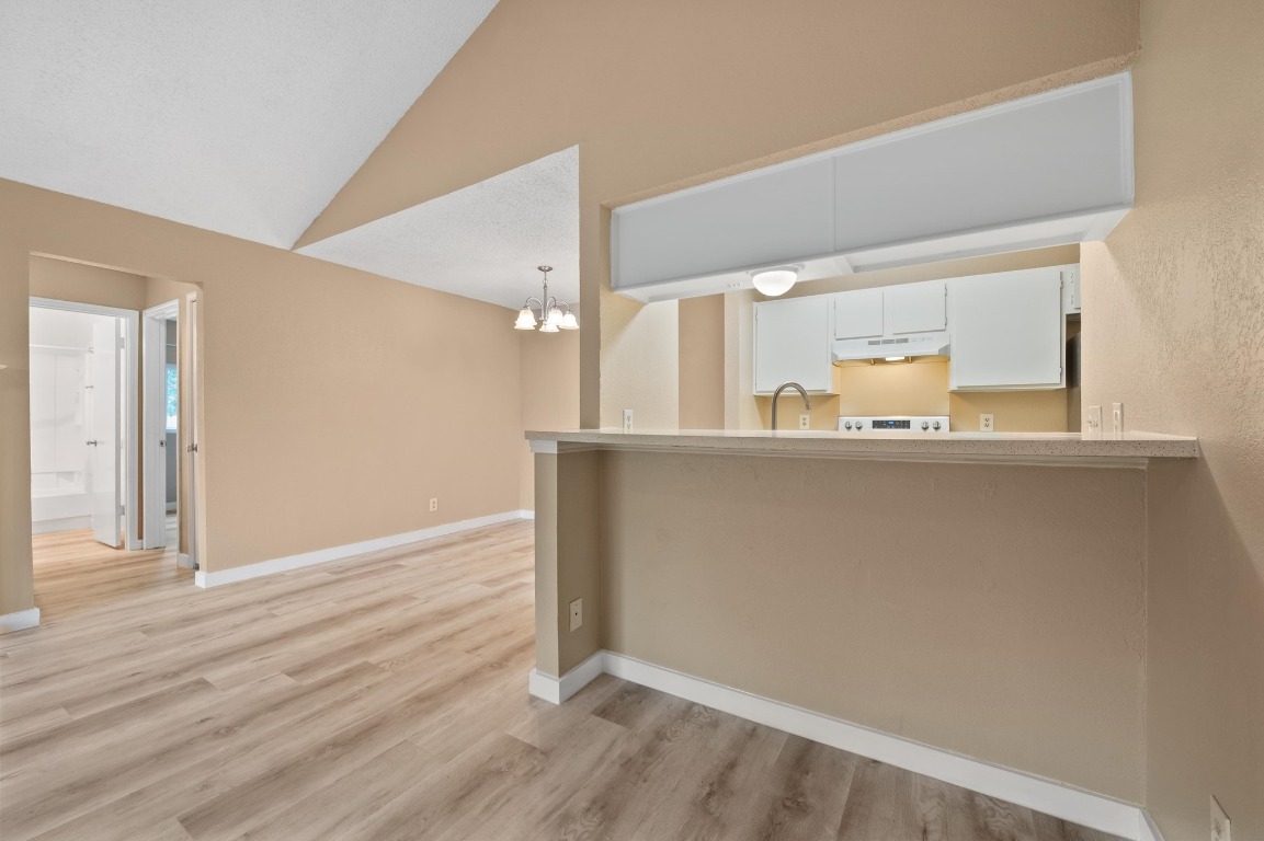 16016 Fitchburg Circle Pflugerville, TX 78660 - Photo 7 of 22 a view of a kitchen with wooden floor and cabinets