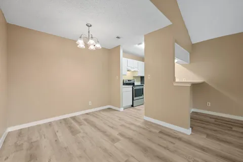 a view of a kitchen with wooden floor and a sink