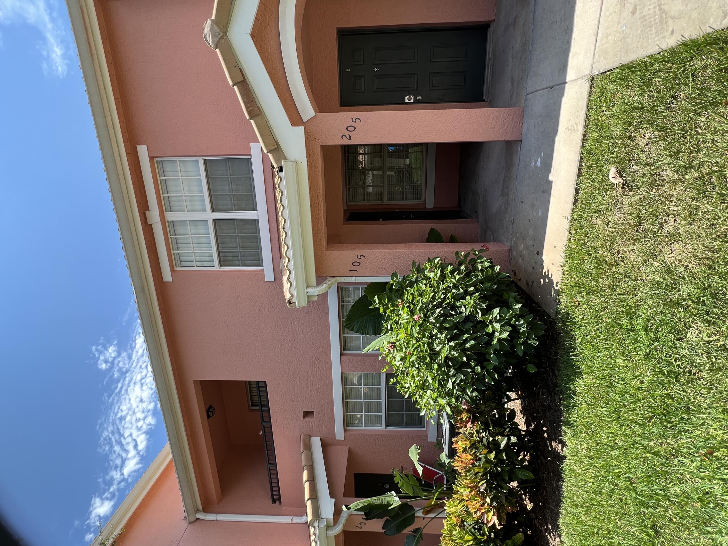 138 Southwest Peacock Boulevard, Unit 20105 Port St. Lucie, FL 34986 - Photo 1 of 19 a view of a house with a garden