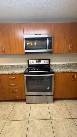 a stove top oven sitting inside of a kitchen