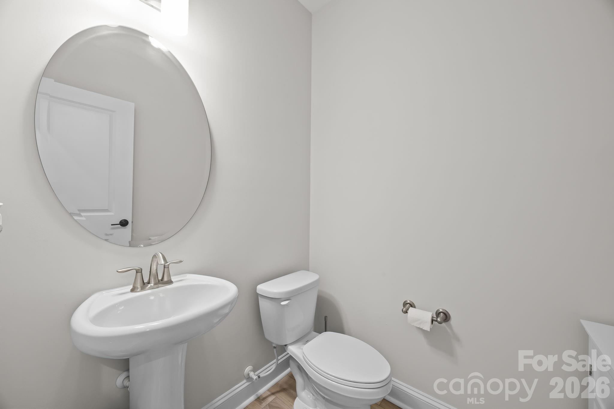 11224 Glasden Road Charlotte, NC 28278 - Photo 21 of 45 a bathroom with a sink a mirror and a toilet