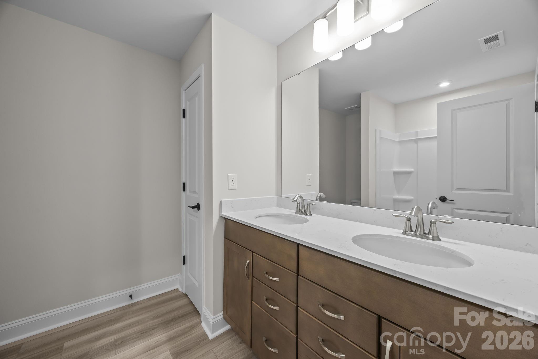 11224 Glasden Road Charlotte, NC 28278 - Photo 33 of 45 a bathroom with a sink double vanity and a mirror