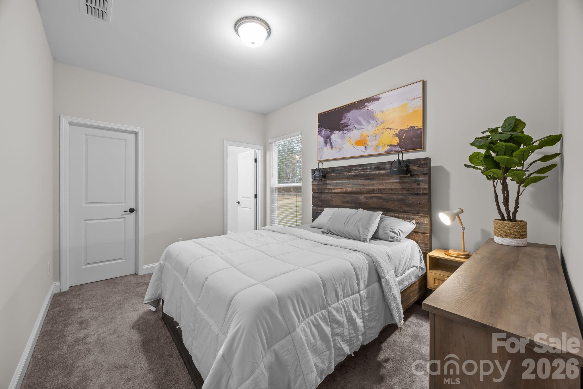 11224 Glasden Road Charlotte, NC 28278 - Photo 36 of 45 a bedroom with a bed and a flat screen tv