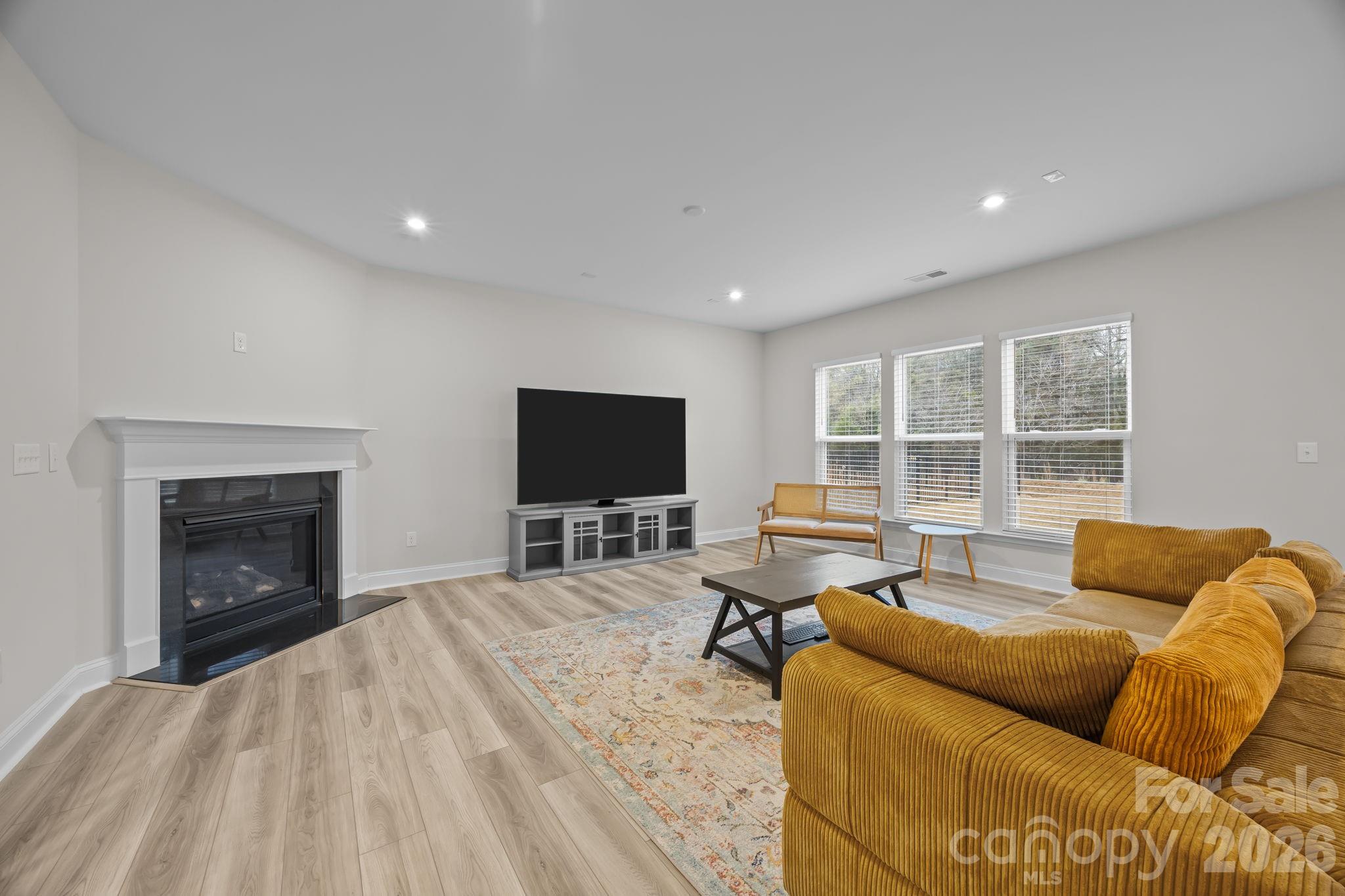 11224 Glasden Road Charlotte, NC 28278 - Photo 10 of 45 a living room with furniture and a flat screen tv