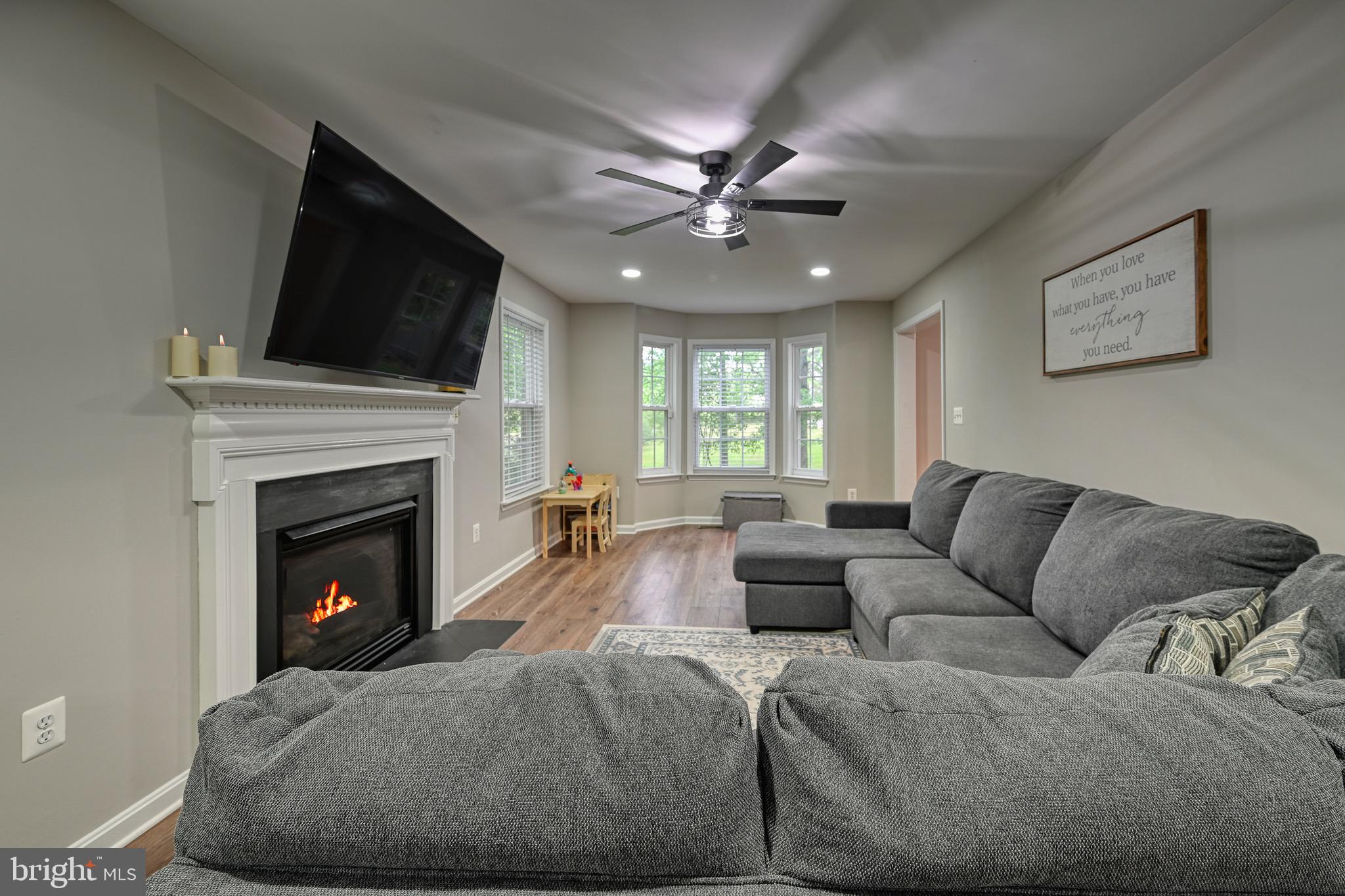 3605 Burton Road Bumpass, VA 23024 - Photo 12 of 39 a living room with furniture a fireplace and a flat screen tv