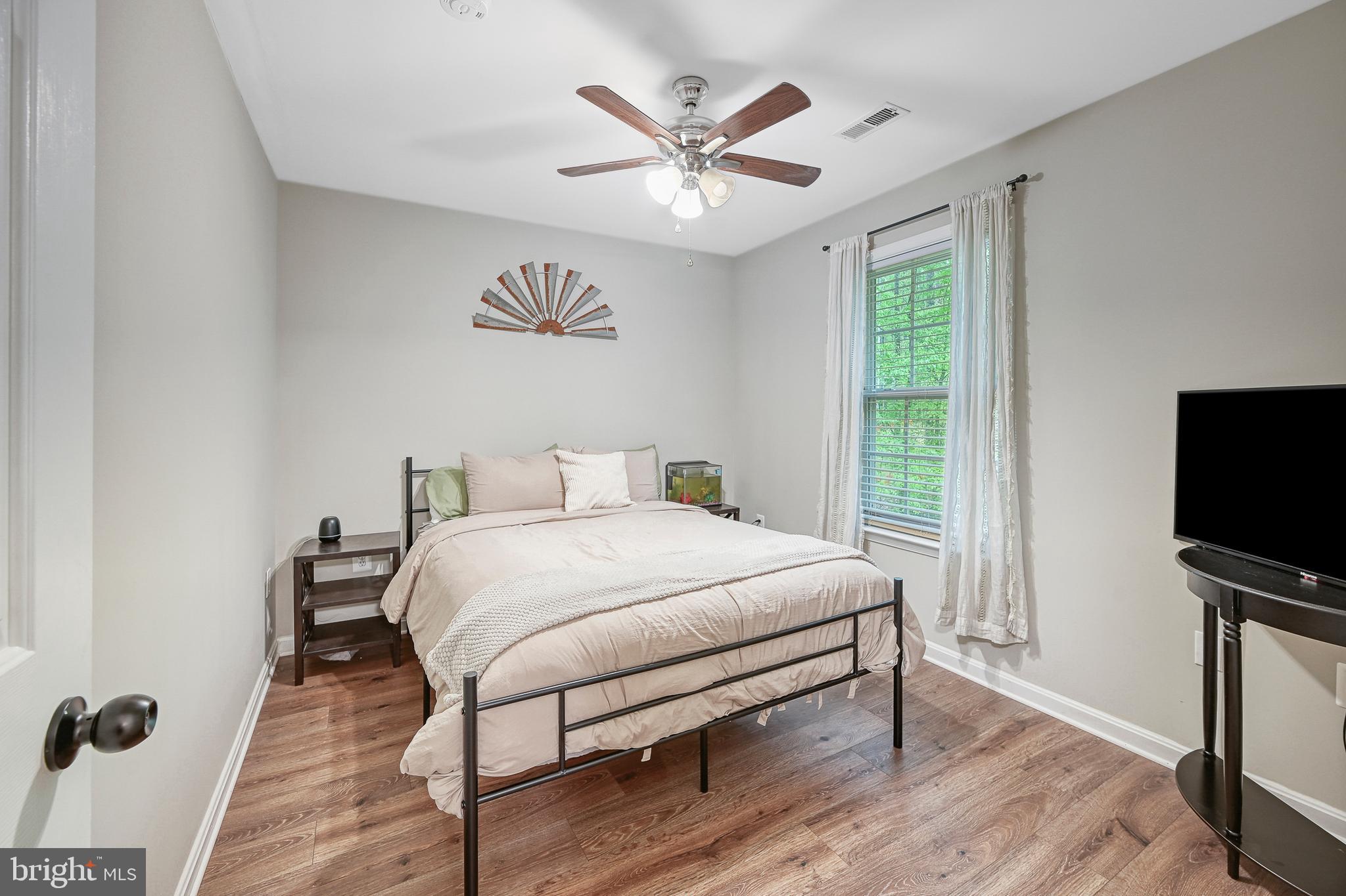 3605 Burton Road Bumpass, VA 23024 - Photo 24 of 39 a bedroom with a bed and a flat screen tv