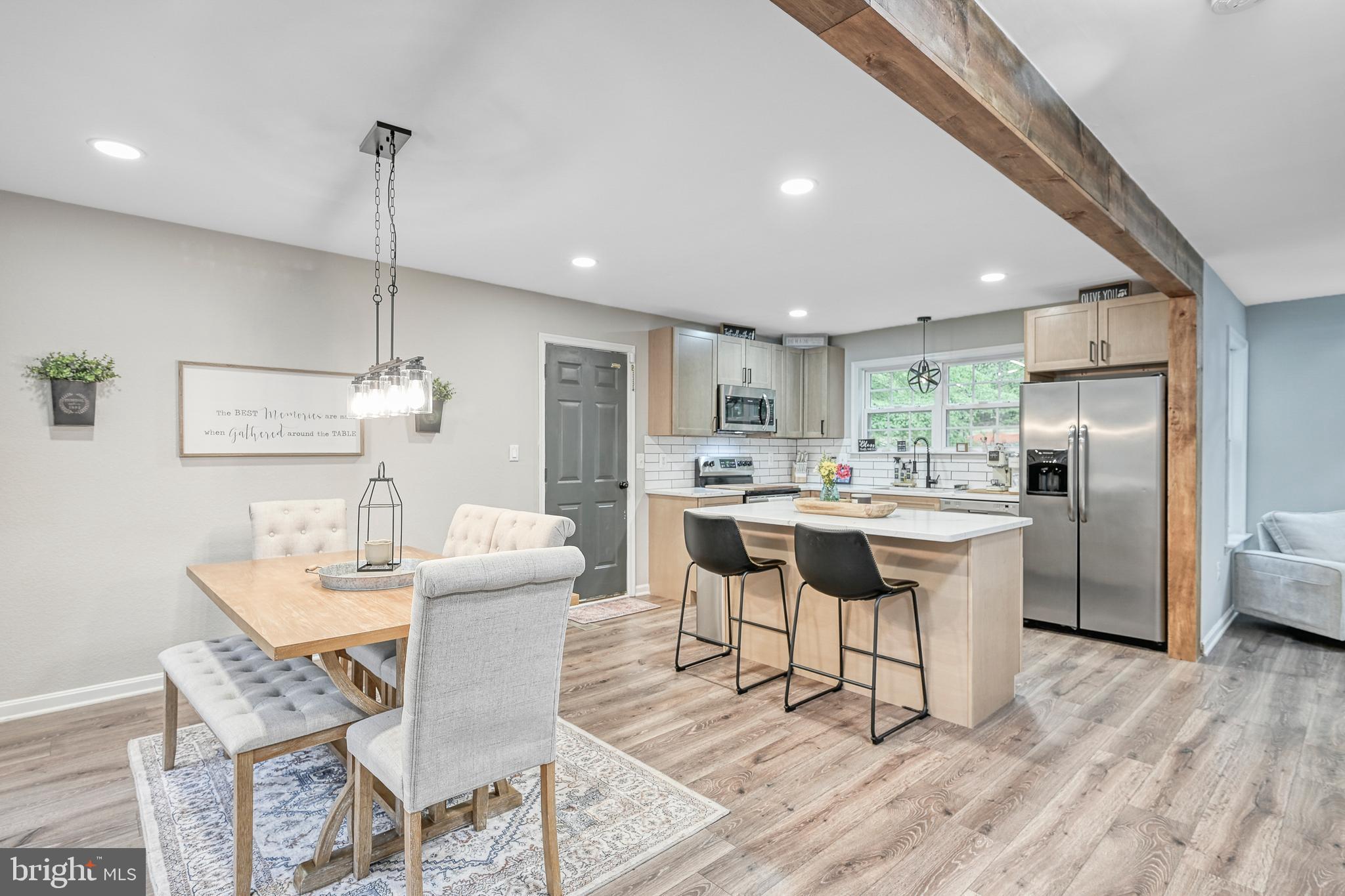 3605 Burton Road Bumpass, VA 23024 - Photo 3 of 39 a kitchen with a dining table chairs and wooden floor