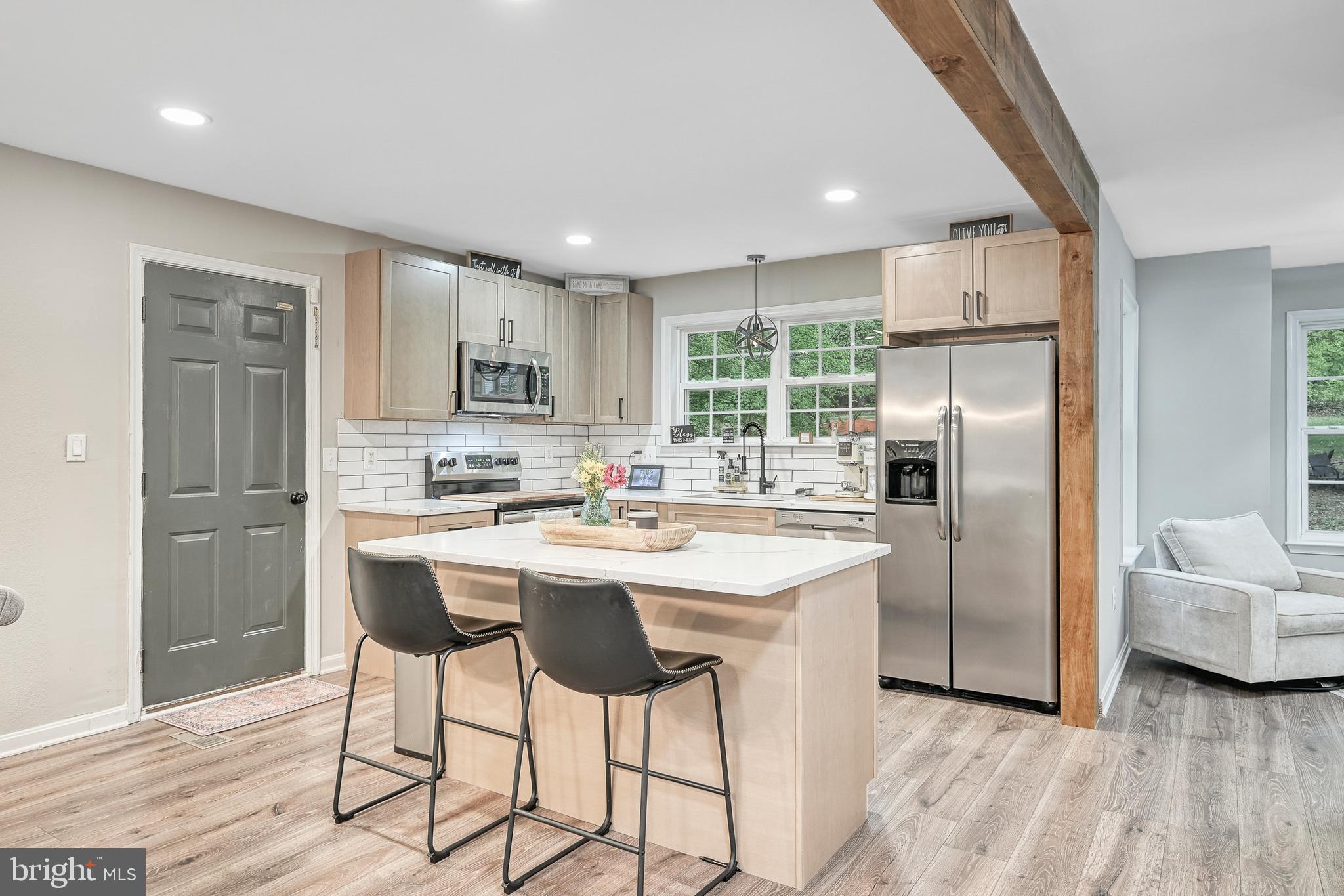 3605 Burton Road Bumpass, VA 23024 - Photo 6 of 39 a kitchen with stainless steel appliances granite countertop a refrigerator a sink a stove a dining table and chairs