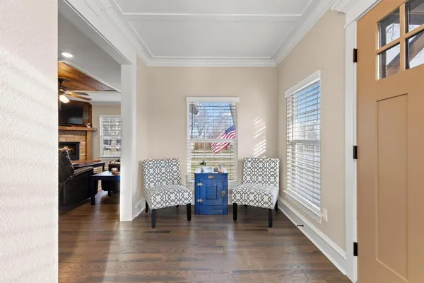a view of hallway with livingroom and wooden floor