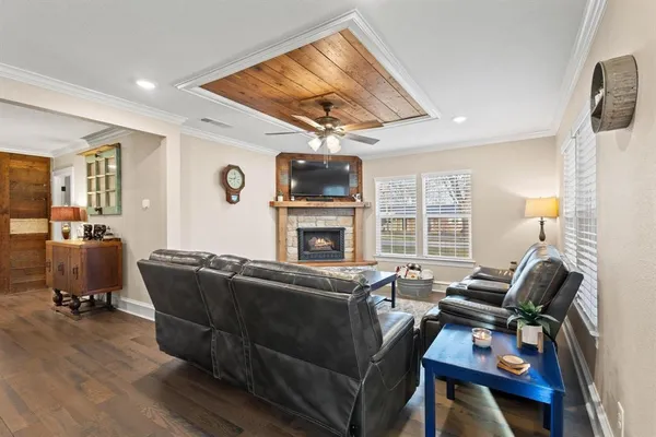 a living room with furniture a flat screen tv and a fireplace
