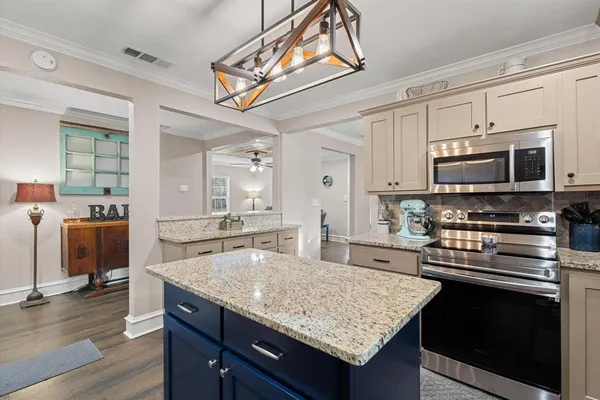 a large kitchen with a table and chairs in it