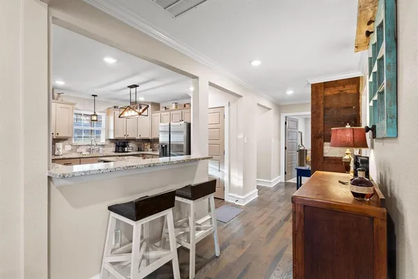 a view of a dining room with furniture wooden floor and chandelier