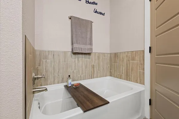 a bathroom with a granite countertop sink toilet and a mirror